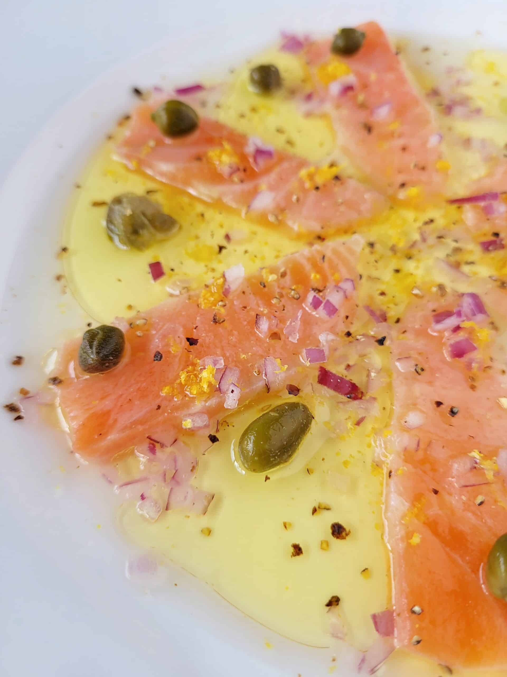 close up shot of an individual serve of salmon crudo.